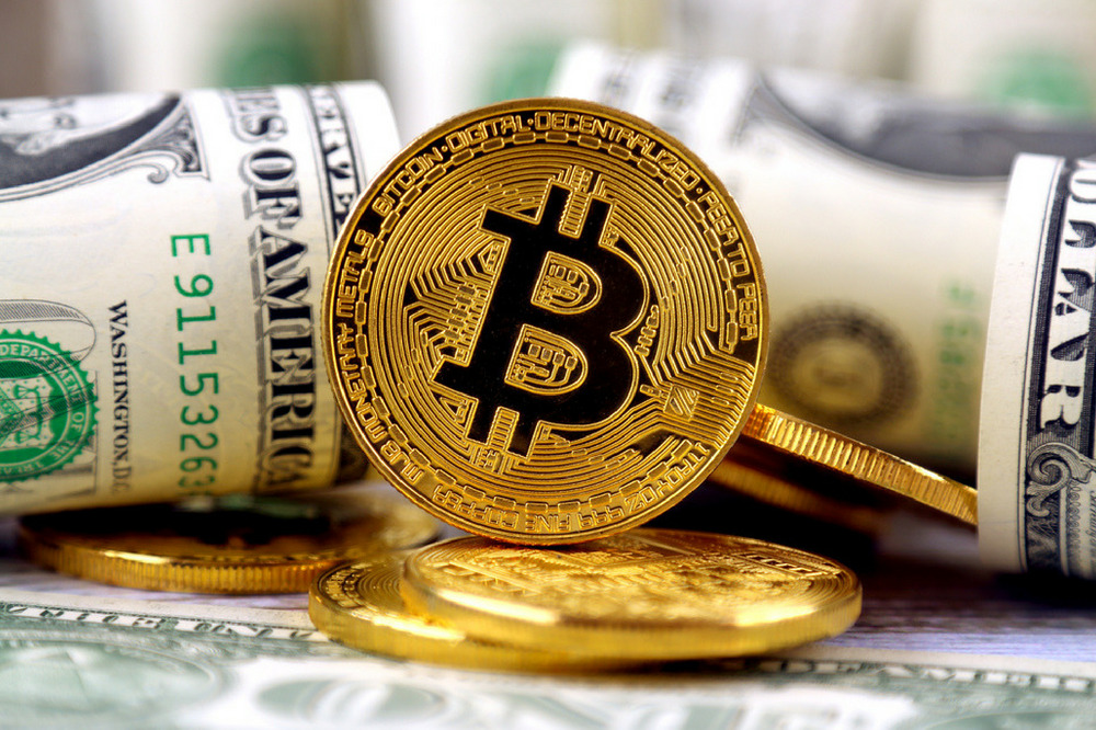 Crypto Estate Planning Multiple Dollar Bills with a Coin inscribed with Bitcoin logo | Dailycoin.com