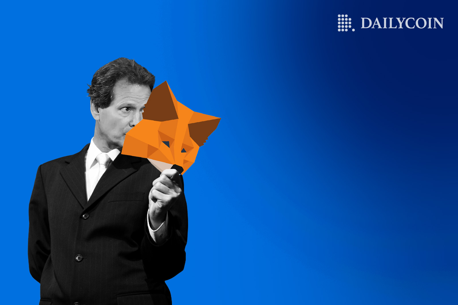 Dan Schulman holds a polygonal fox mask that represents MetaMask