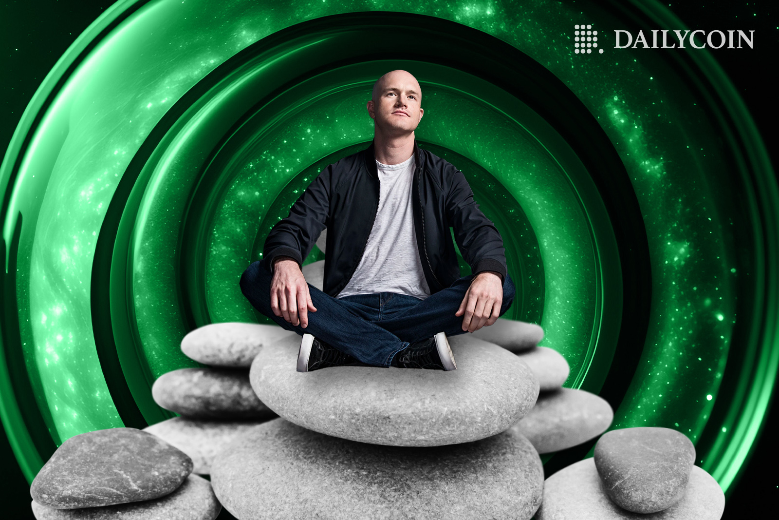 Brian Armstrong sitting on rocks in a zen pose