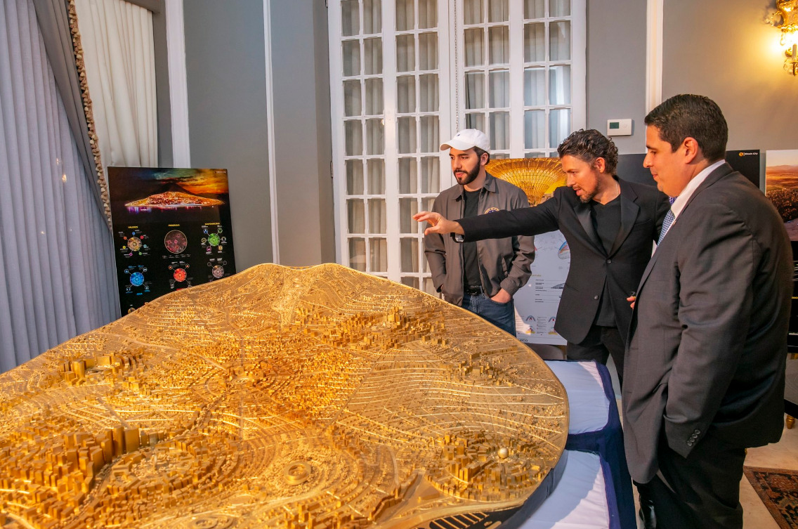 Nayib Bukele standing next to El Salvador Bitcoin city design.