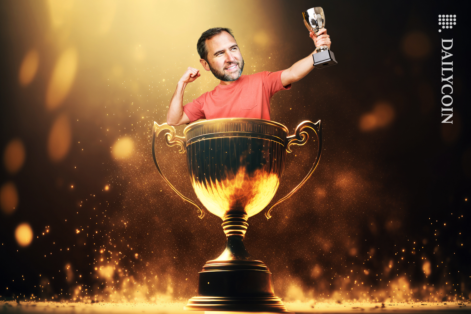 Brad Garlinghouse coming out of the trophy whilst also holding a trophy and celebrating.