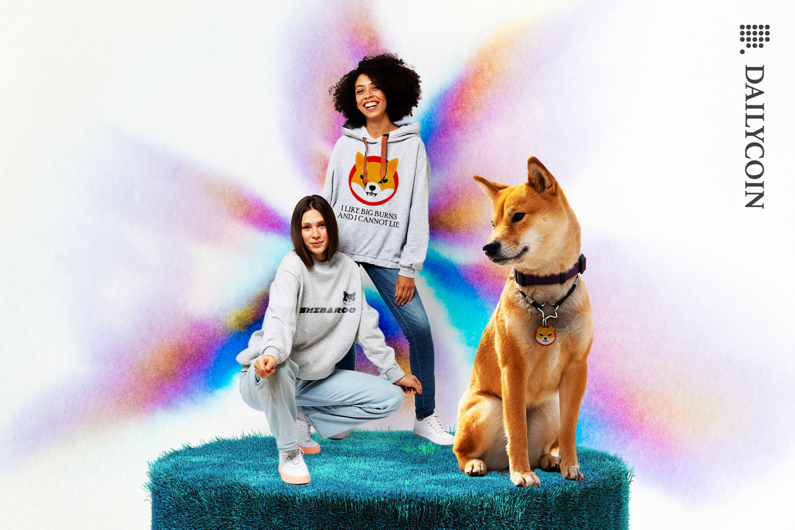 Girls wearing shiba inu jumpers, shiba inu sitting next to them.