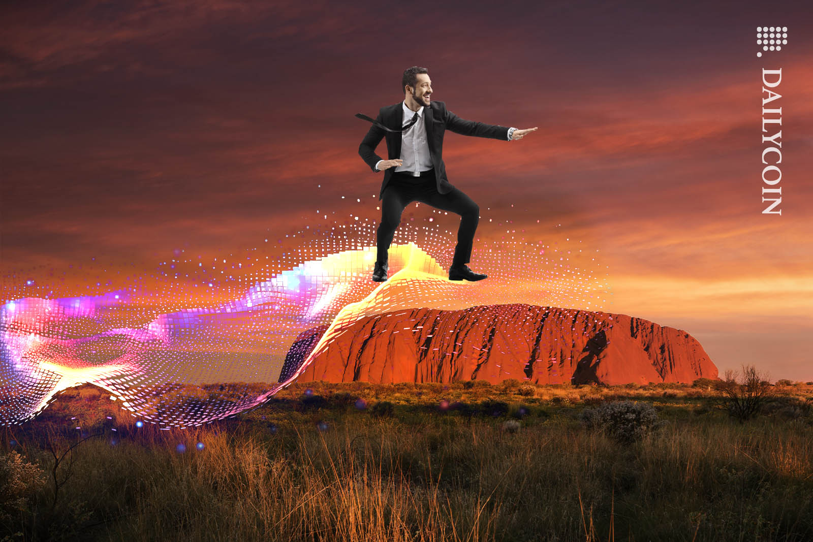 Man in suit surfing a digital wave above the red rock of Uluru.