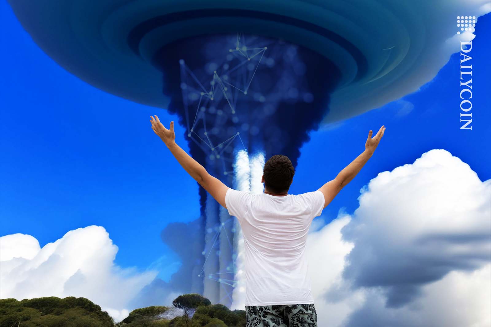 Mand admiring a large cloud outflow with arms in the air.