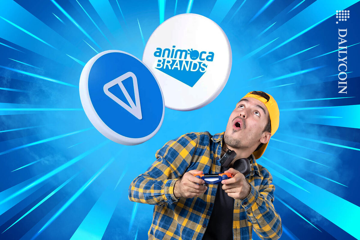 Gamer looking shocked as he is staring at a Ton coin and an Animoca coin above his head.