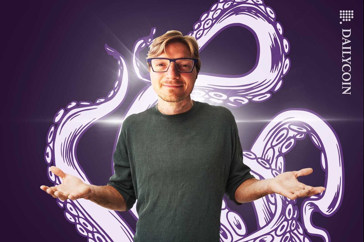 Jesse Powell smiling in front of a Kraken graffiti.