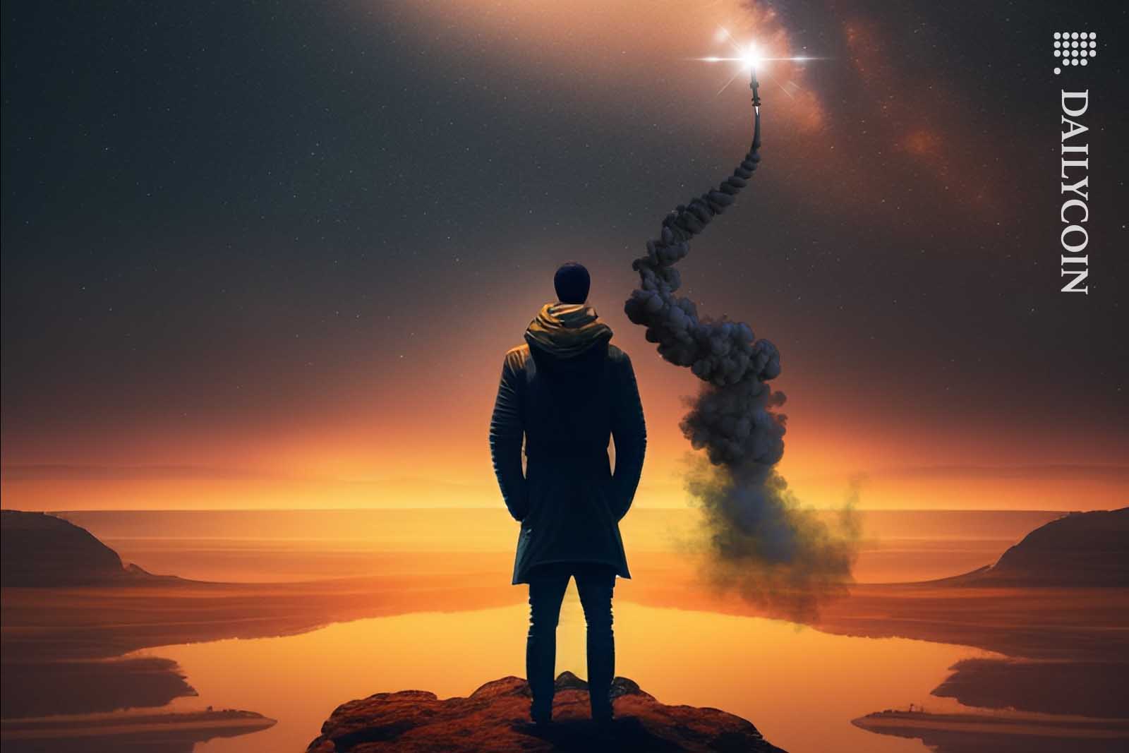Man looking at a rocket flying high on the night sky.