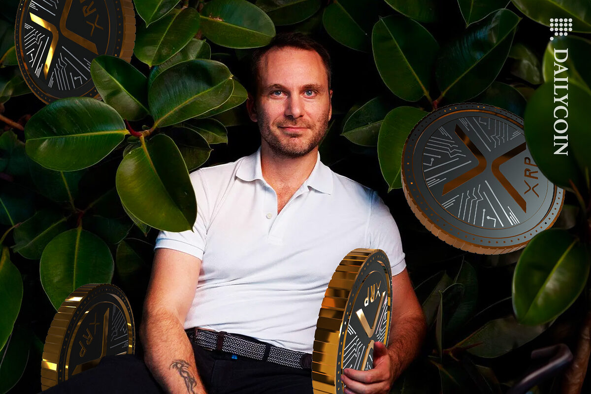 Bitfinex CTO Paolo Ardoino holding XRP coins in the bushes.