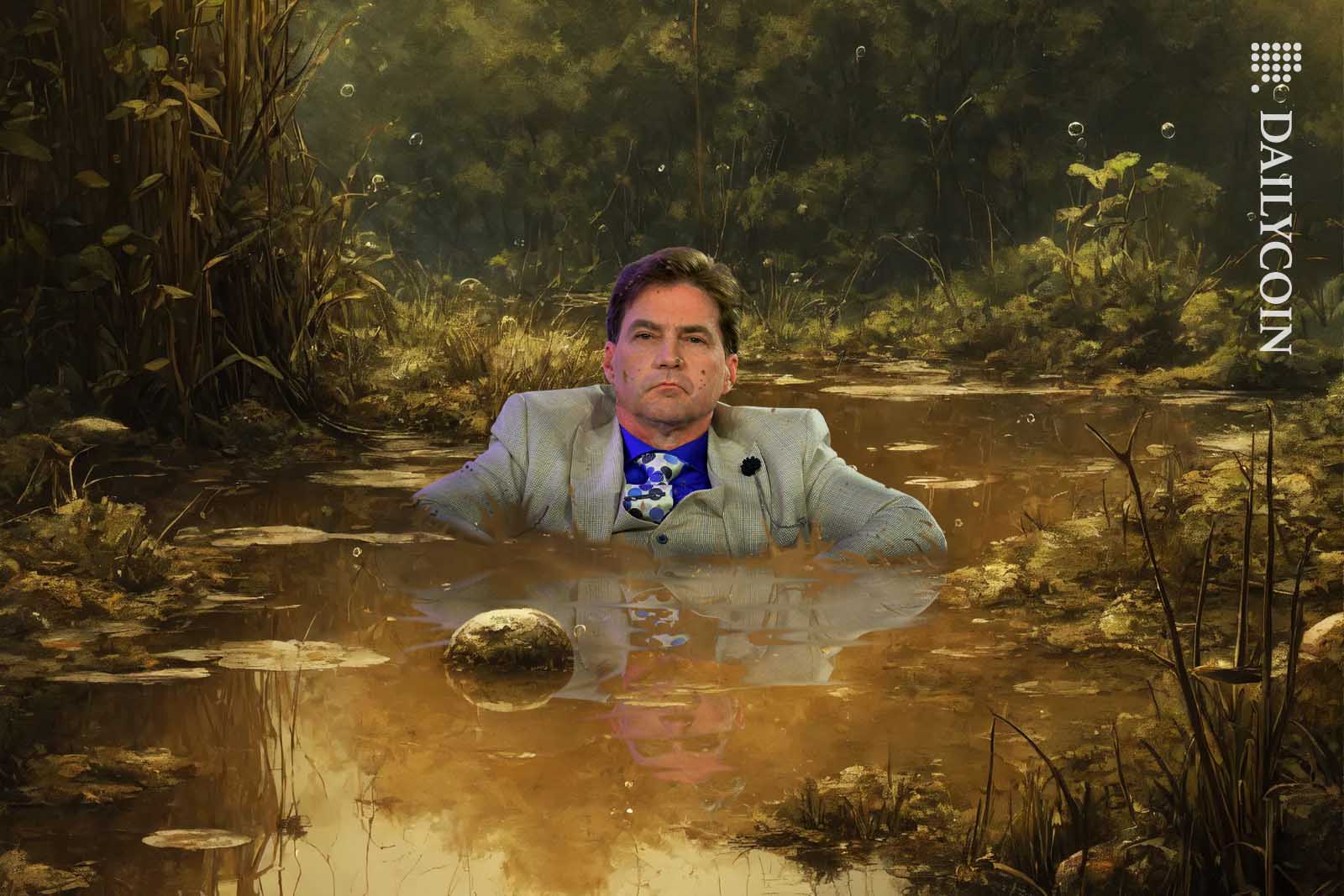 Craig Wright sitting in stinky swamp chest deep.