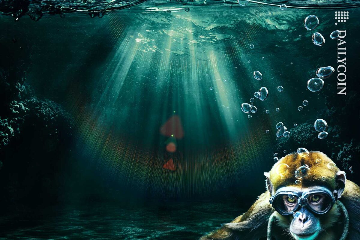 Monkey sitting on the bottom of the sea wearing scuba diving gear.