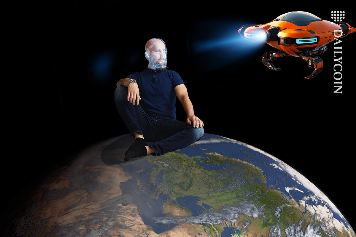 Man getting his identity checked by a flyiing robot whilst sitting on top of the world.