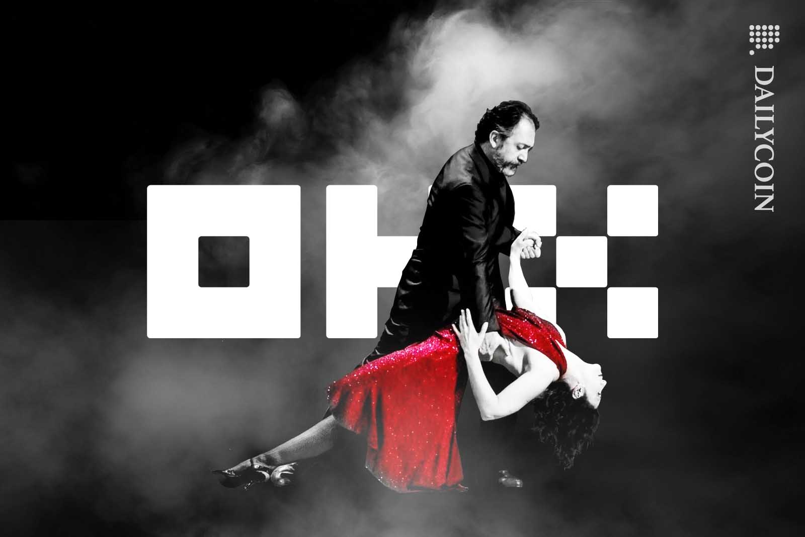 Argentine couple dancing tango in front of a huge OKX logo.