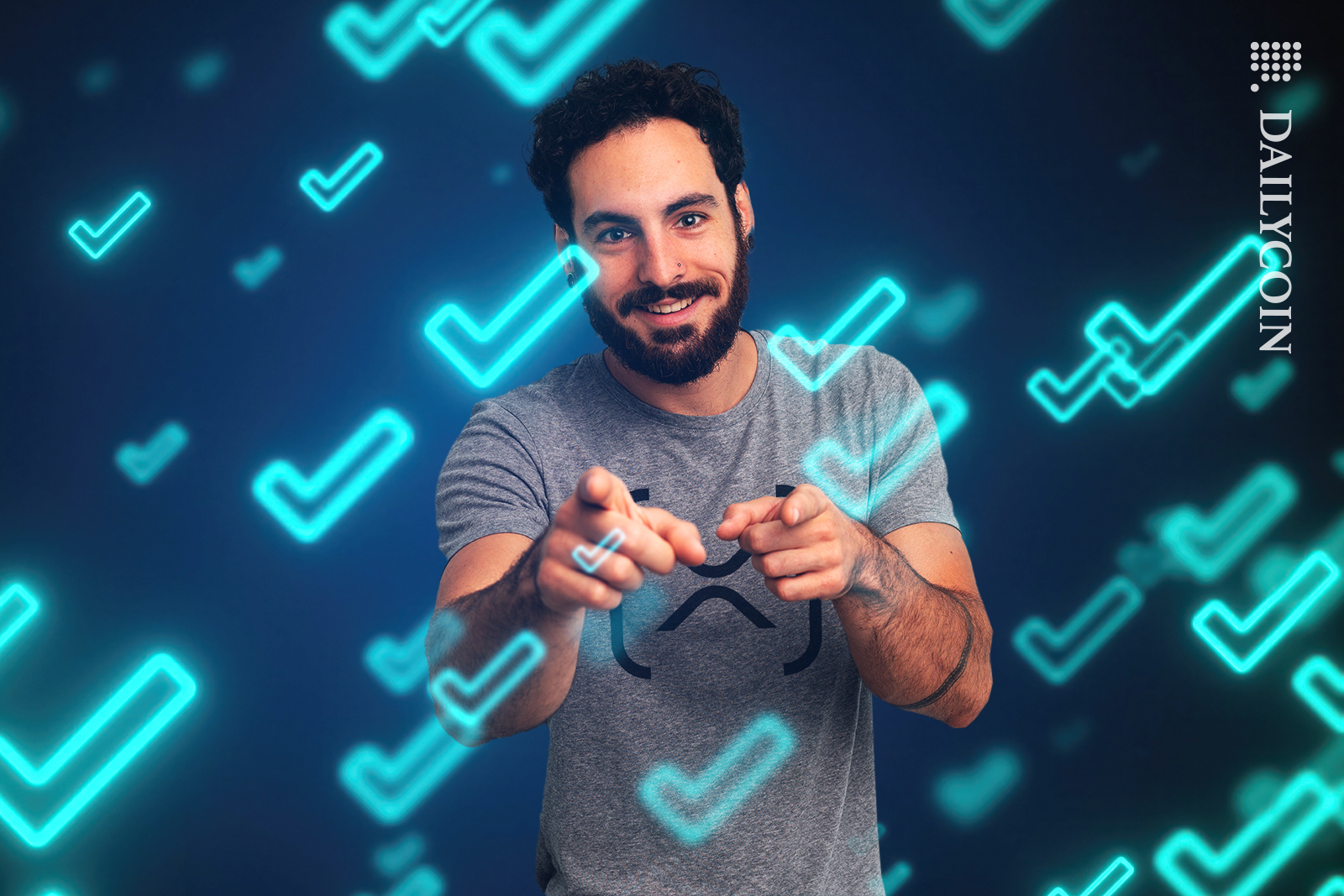 Guy pointing to you, wearing XRP Ledger t-shirt in blue tick space.