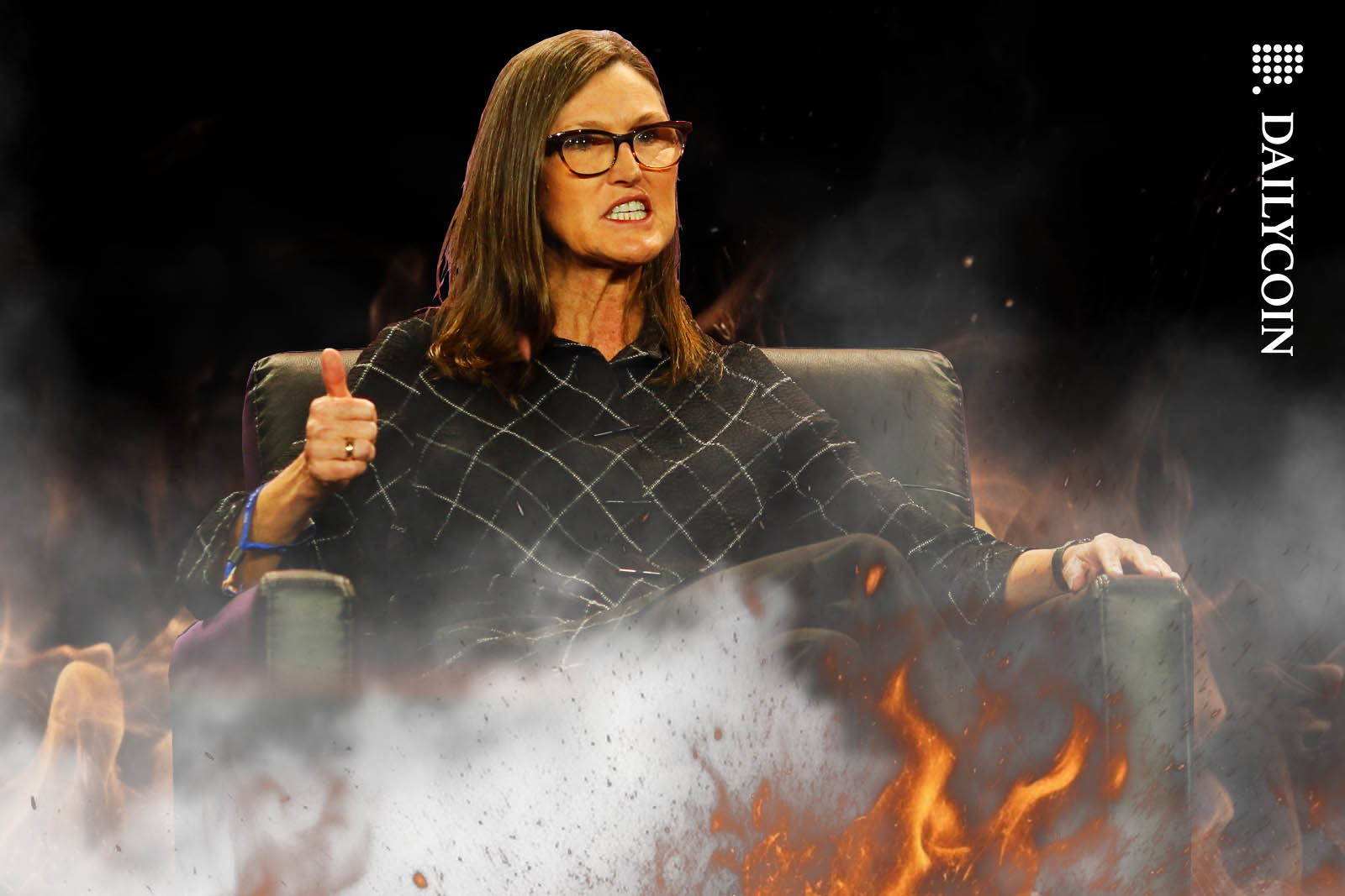 Cathie Woods in fire and smoke showing thumbs up, but looks angry at the same time.