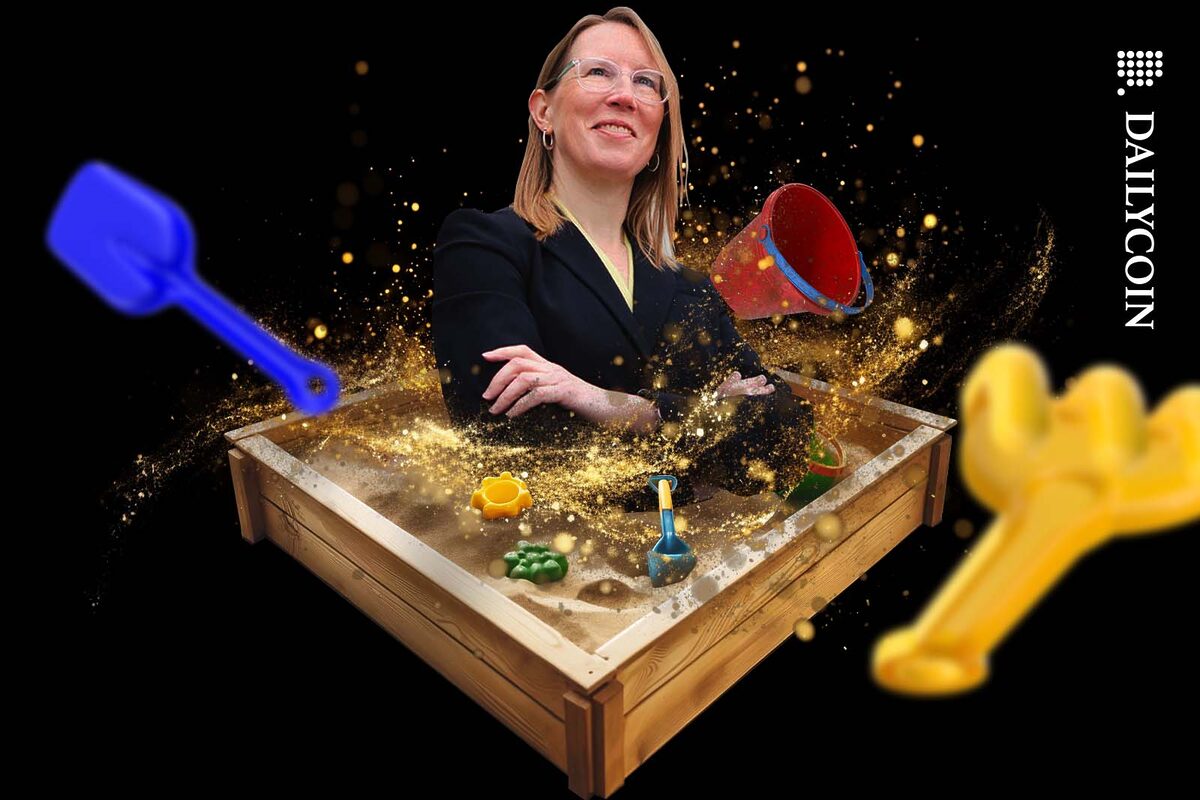 Hester M. Pierce emerging from a sandbox full of toys.