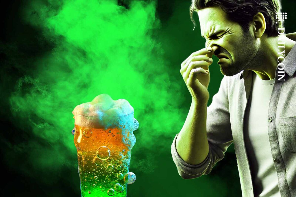 Man smelling a really stinky glass of BEER.