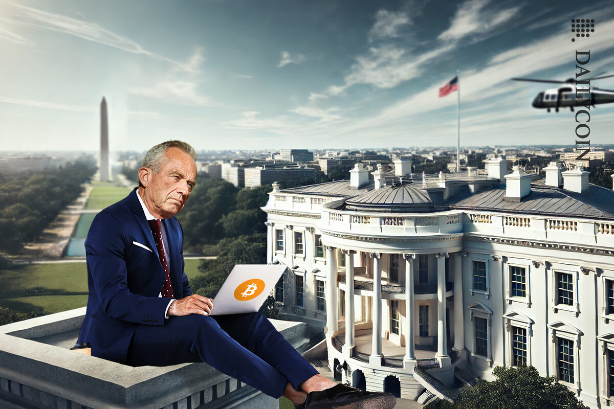 RFK Jr. sitting on top of a tower building next to the white house, trading his crypto. Bitcoin sticker is on his laptop.