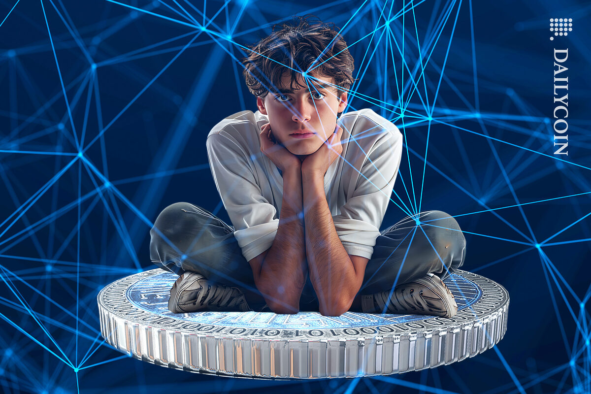 Guy sitting uncomfortably on a Cardano coin.