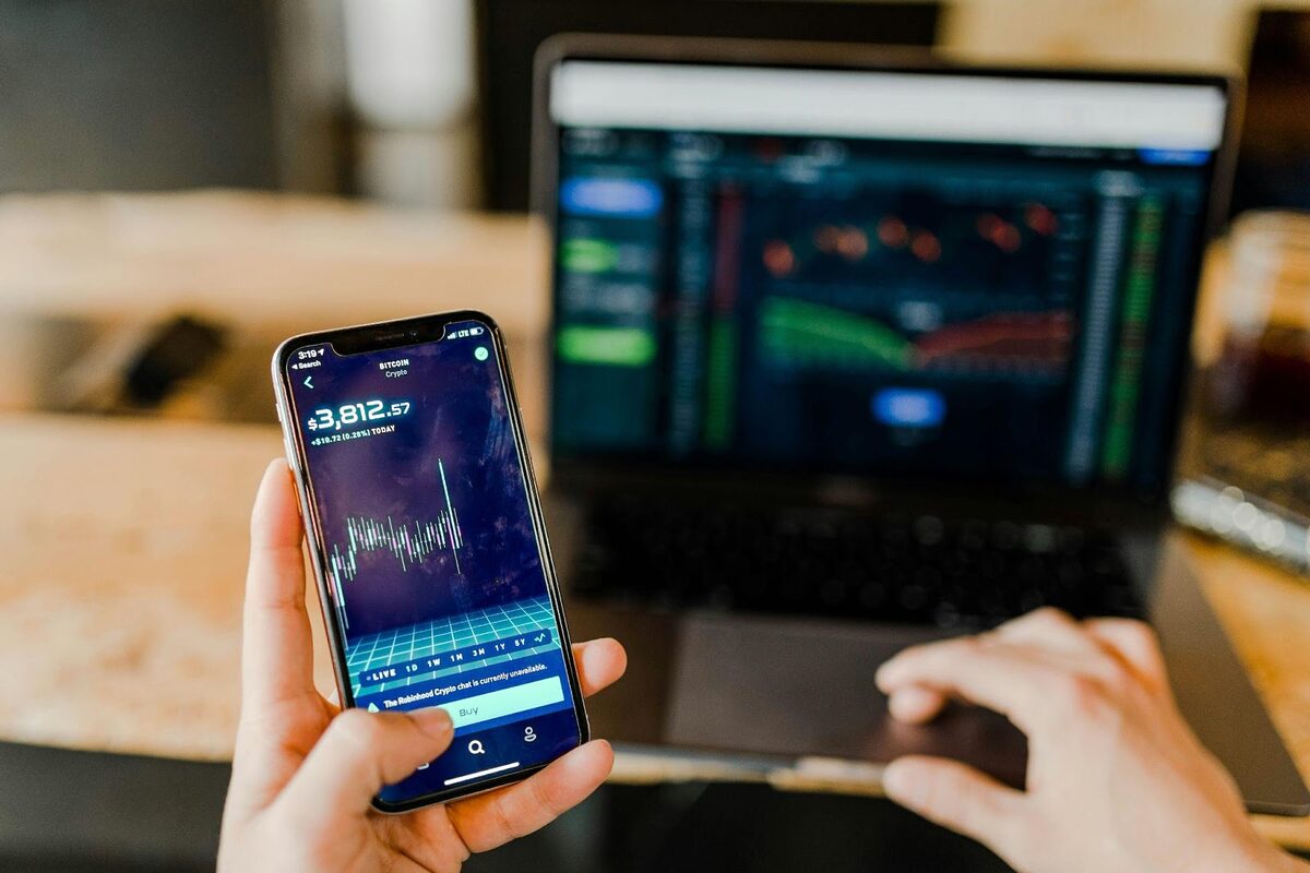 Man trading stocks on his phone.