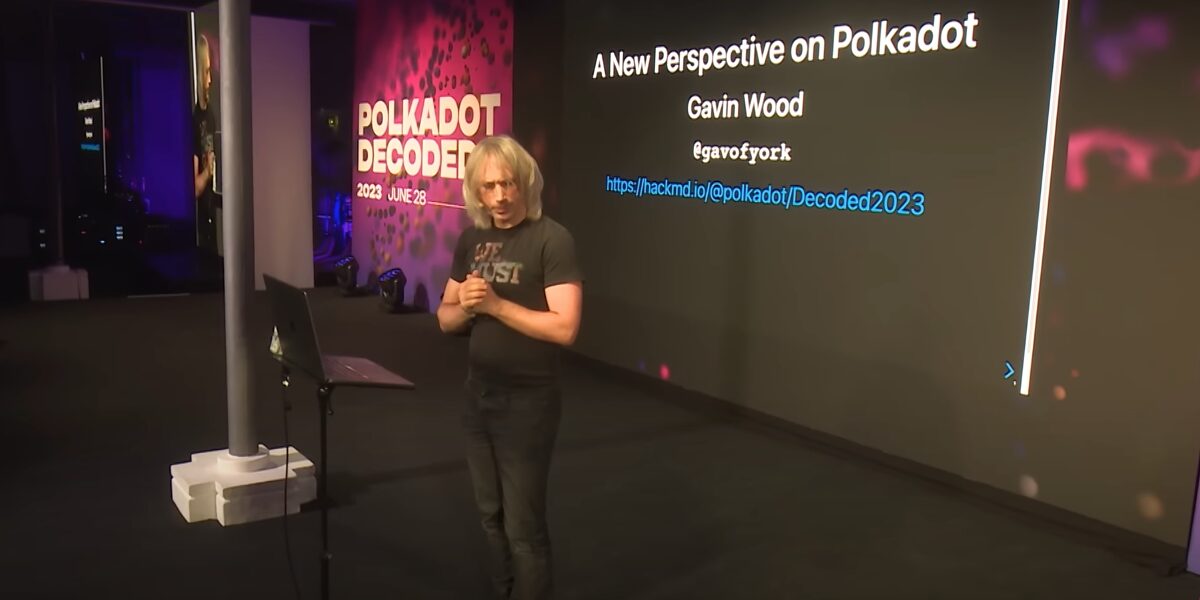 Polkadot co-founder Gavin Wood speaking at the Polkadot Decoded conference in 2023. A board behind him says "A New Perspective on Polkadot".