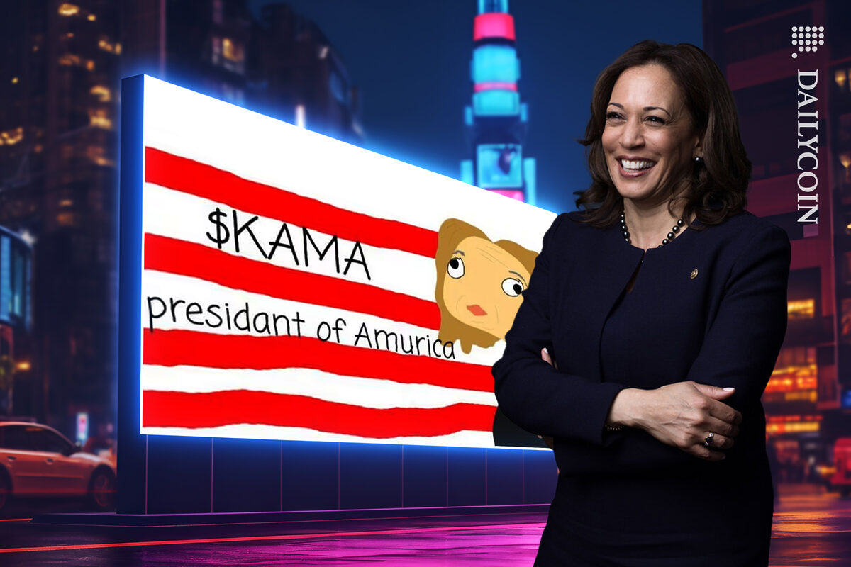 Kamala Harris next to the billboard of her meme coin KAMA standing happy.