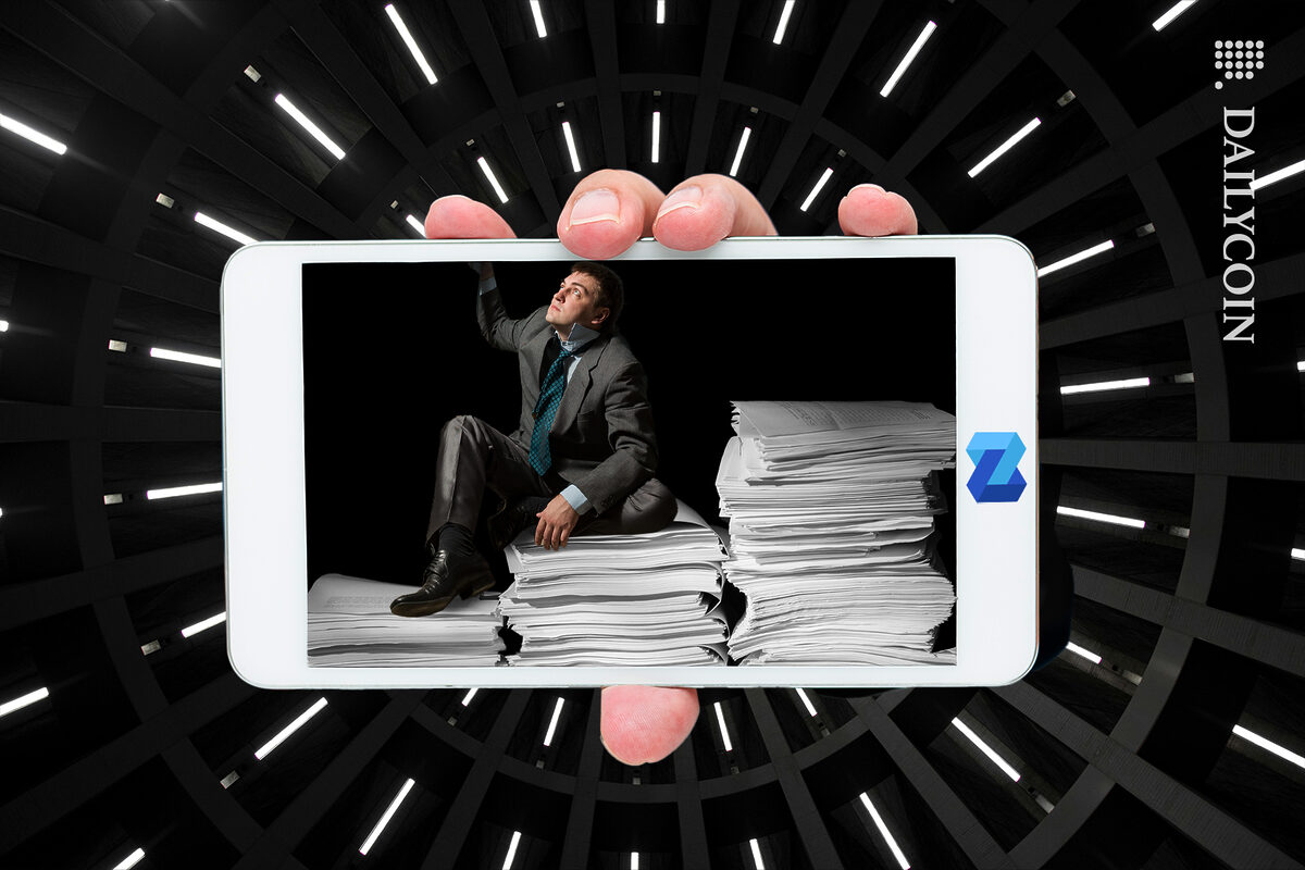 Guy stuck in a NEXO device with stacks of paper.