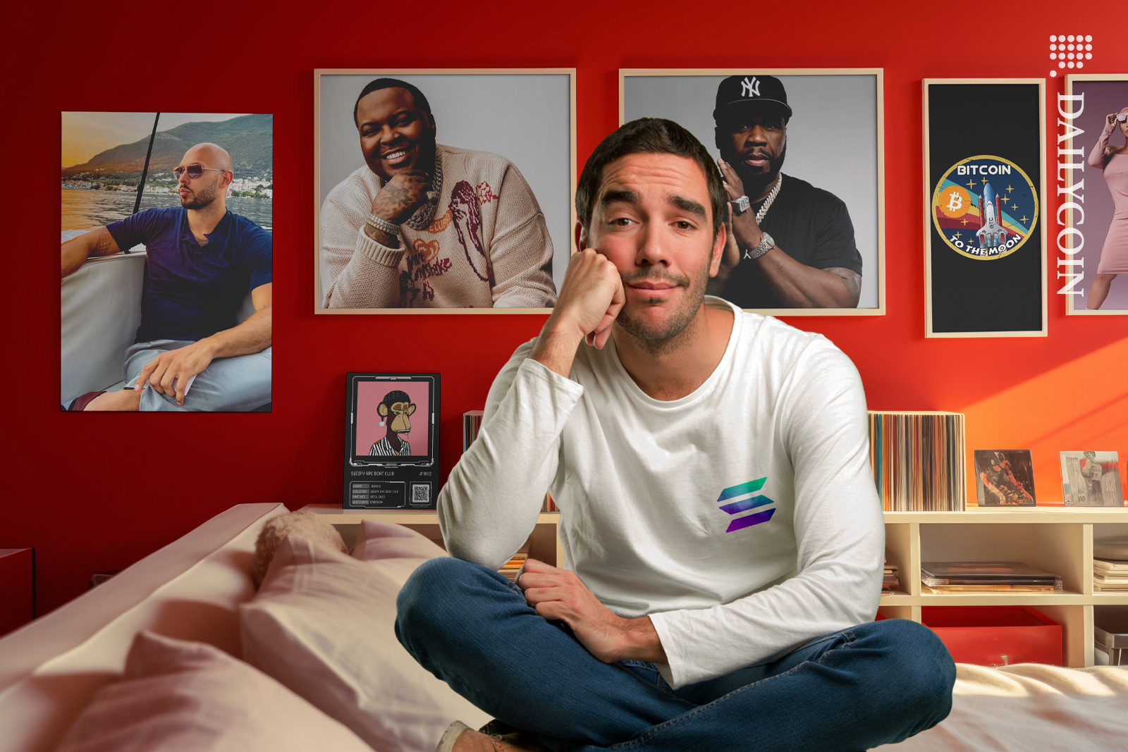 Guy sitting in his bedroom, wearing a solana shirt. disappointed with his hall of fame poster wall.