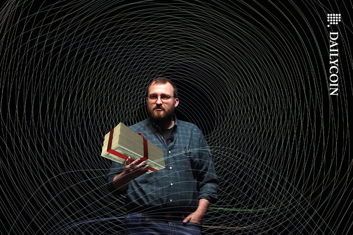Charles Hoskinson of Cardano offering a big stack of money as a gift.