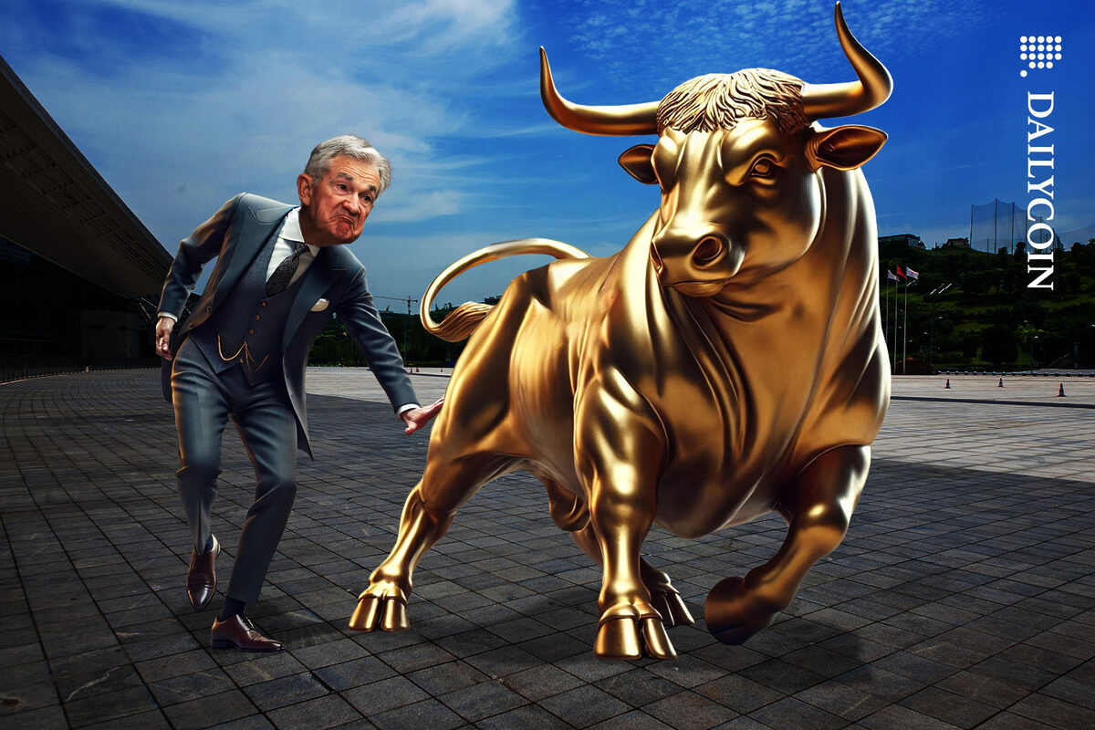 Peter Brandt smacking a golden bull on the bottom.