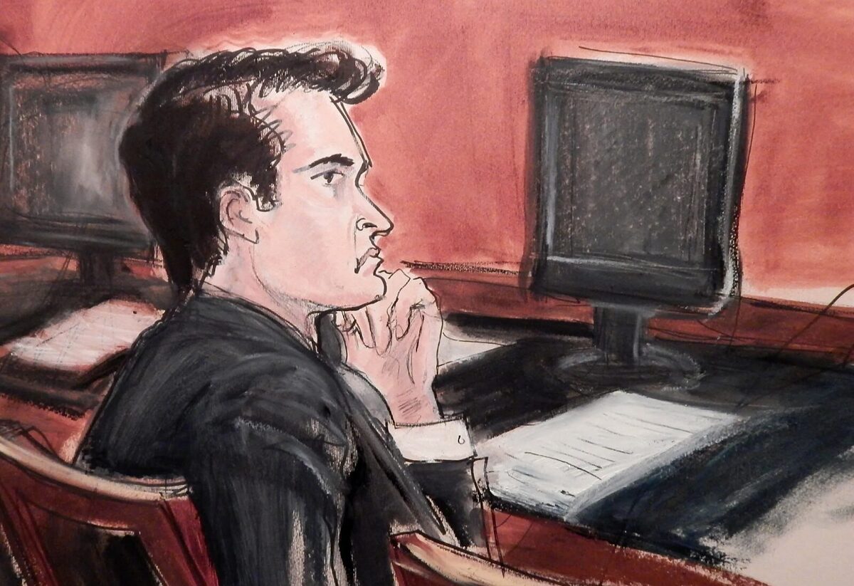 A sketch of Ross Ulbricht in court sitting at a desk with a glum look on his face.