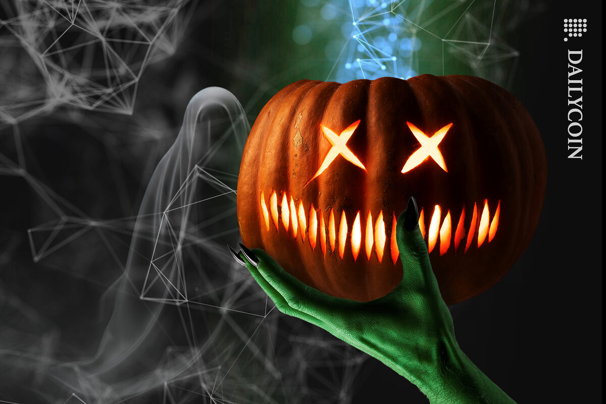 A witches hand holding a scary pumpkin with DEFI connection going up.
