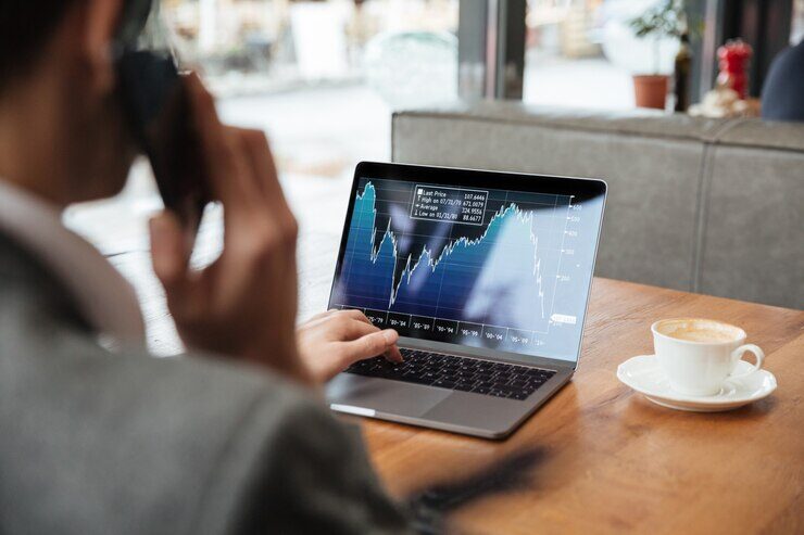 A man using a laptop to trade crypto.