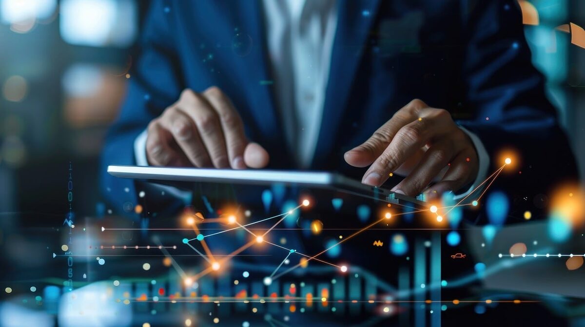 A man using an Ipad to trade crypto.