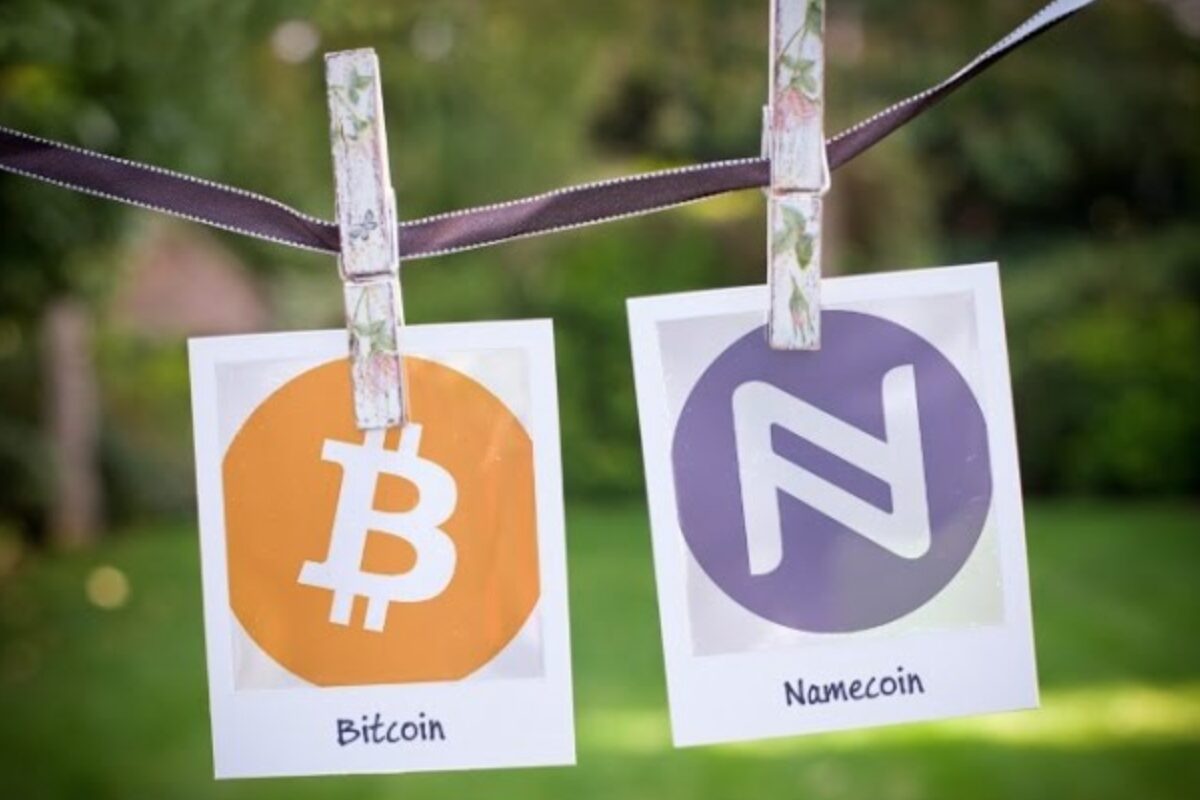 Bitcoin and Namecoin side by side on a clothing line being held up by two separate pegs.
