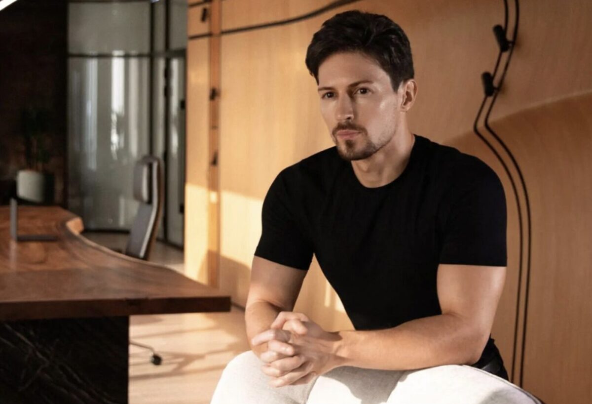 Pavel Durov, head of Telegram, sitting down with a black shirt and his hands clamped together.