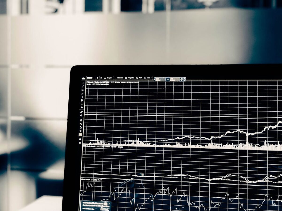 Crypto trading chart on a laptop.