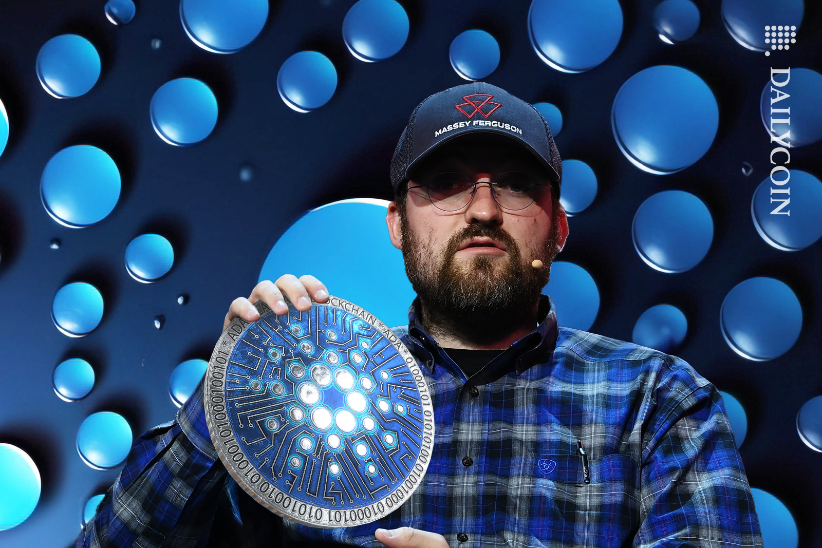 Charles Hoskinson holding up Cardano ADA coin.